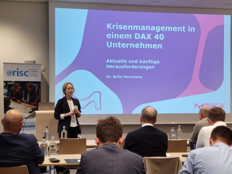Birte Herrmann (Merck) spricht zu Publikum über Krisenmanagement im DAX 40 Unternehmen.
